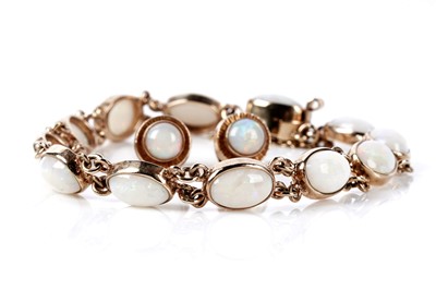 Lot 73 - An opal cabochon bracelet; and a pair of opal stud earrings