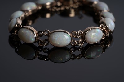 Lot 73 - An opal cabochon bracelet; and a pair of opal stud earrings