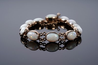Lot 73 - An opal cabochon bracelet; and a pair of opal stud earrings