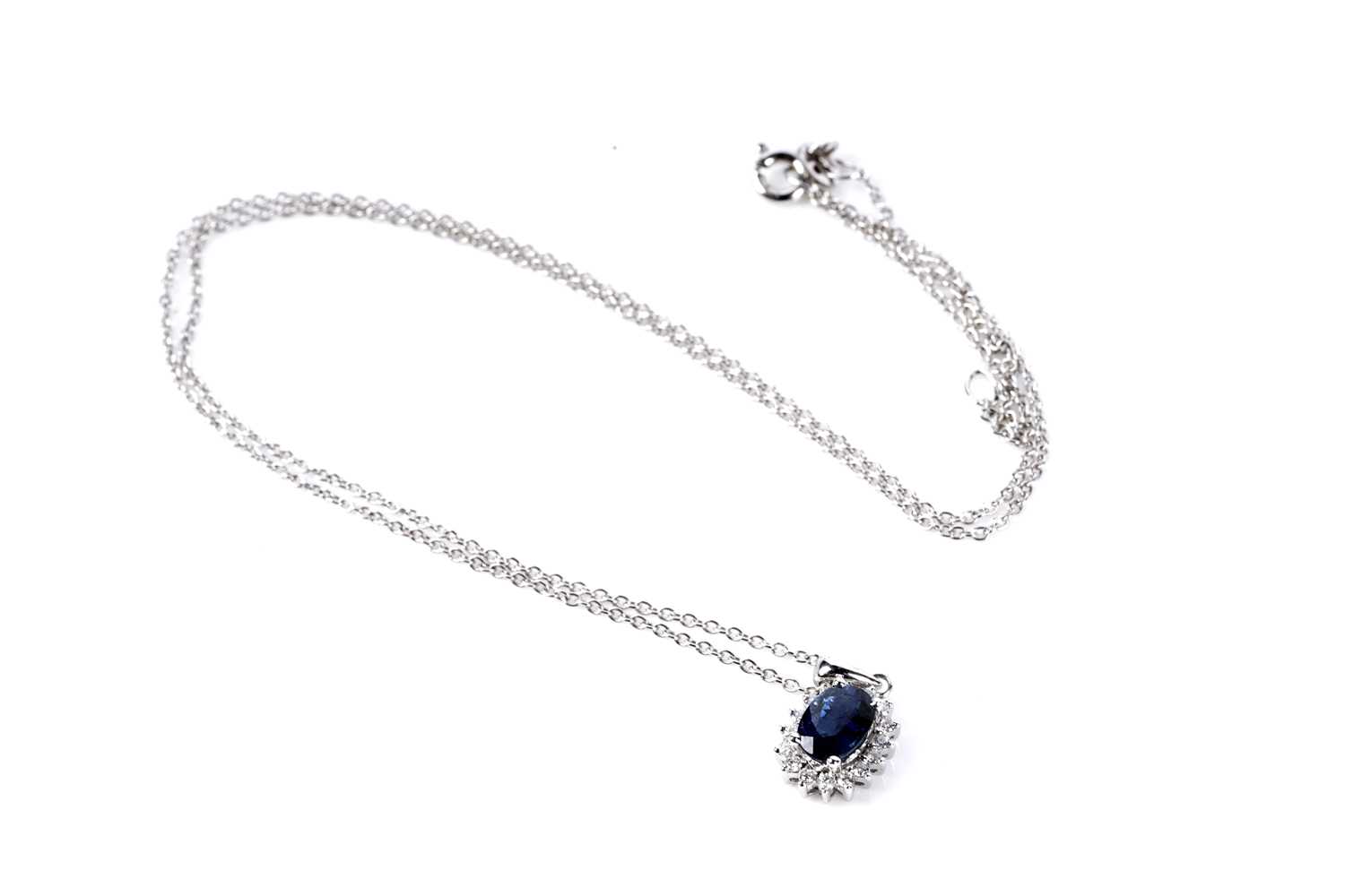 Lot 132 - A sapphire and diamond cluster pendant necklace