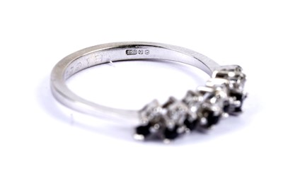Lot 35 - A diamond and sapphire half eternity ring