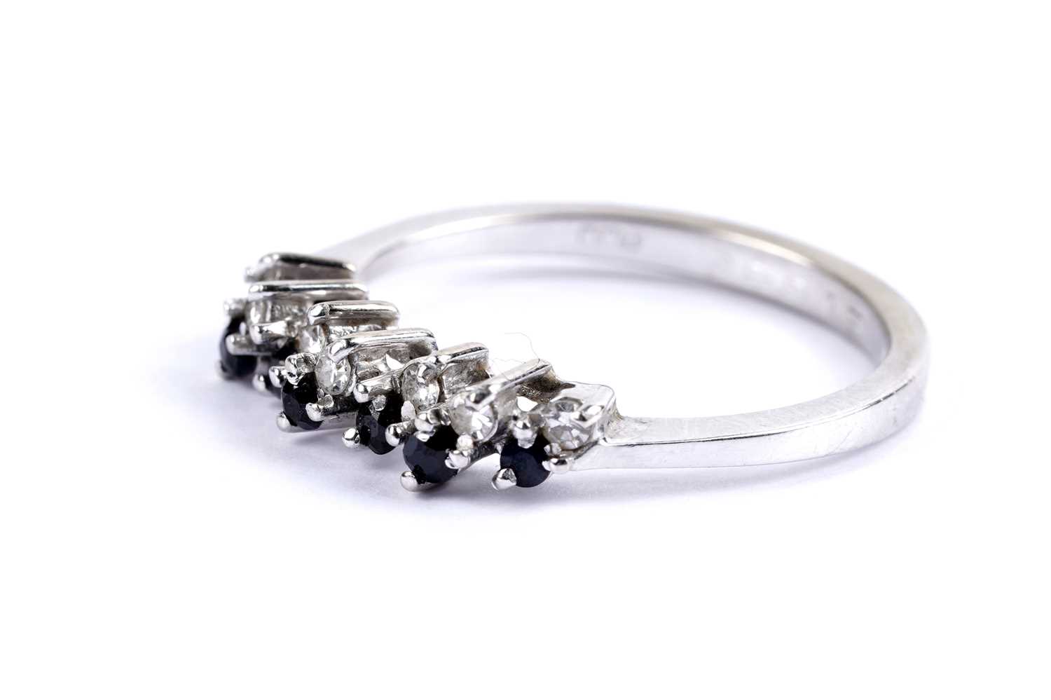 Lot 35 - A diamond and sapphire half eternity ring