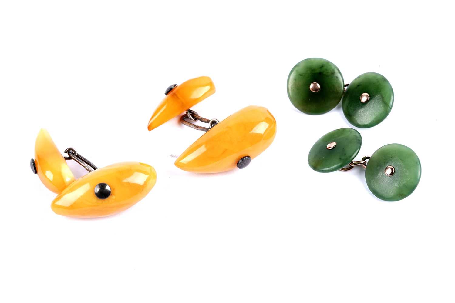 Lot 47 - A pair of jade-coloured stone cufflinks; and a pair of butterscotch amber cufflinks