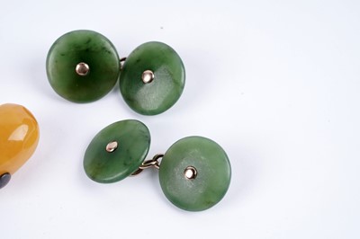 Lot 47 - A pair of jade-coloured stone cufflinks; and a pair of butterscotch amber cufflinks