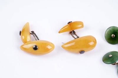 Lot 47 - A pair of jade-coloured stone cufflinks; and a pair of butterscotch amber cufflinks