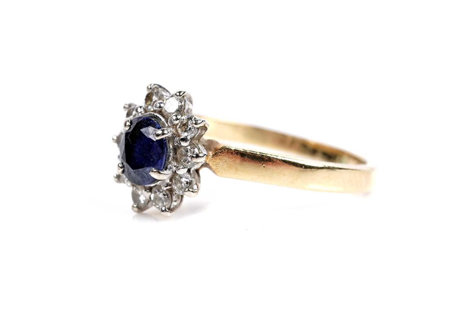 Lot 602 - A sapphire and diamond cluster ring