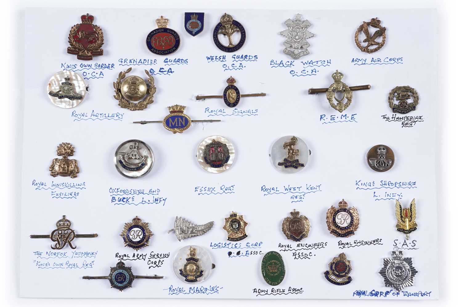 Lot 48 - A display of British and other military lapel badges, sweetheart badges, and other items