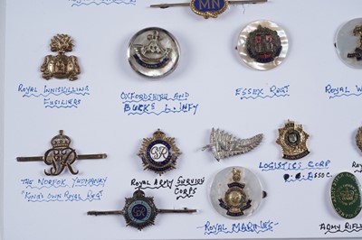 Lot 48 - A display of British and other military lapel badges, sweetheart badges, and other items