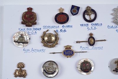 Lot 48 - A display of British and other military lapel badges, sweetheart badges, and other items