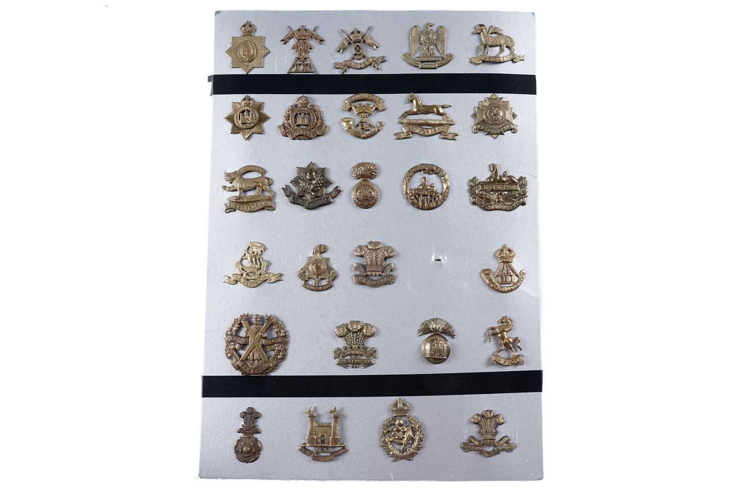Lot 57 - A display of mostly First World War period British military cap badges