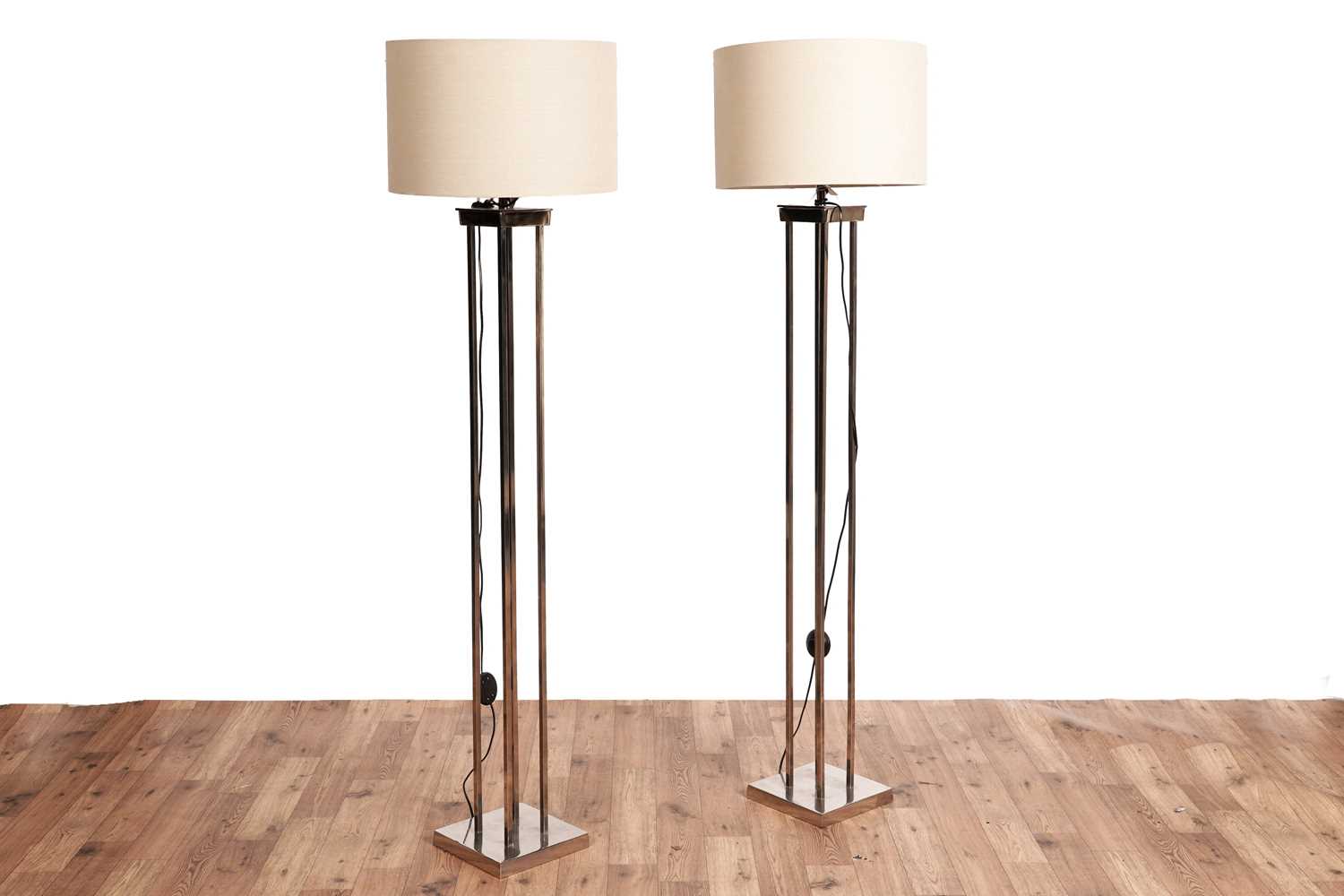Lot 566 - Barker and Stonehouse: a pair of contemporary silvered floor standing lamps