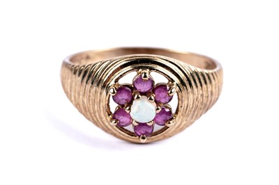 Lot 99 - An opal and ruby flower cluster ring