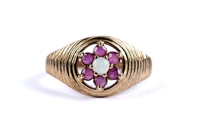Lot 99 - An opal and ruby flower cluster ring
