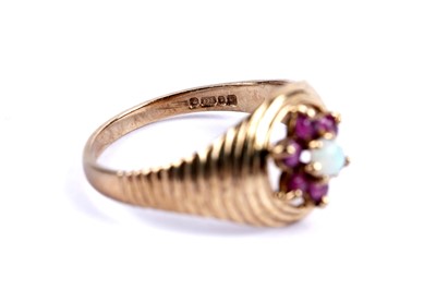 Lot 99 - An opal and ruby flower cluster ring