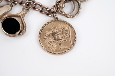 Lot 649 - A 9ct yellow gold bracelet set with a sovereign and other charms