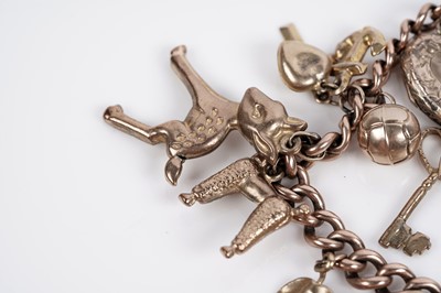 Lot 649 - A 9ct yellow gold bracelet set with a sovereign and other charms
