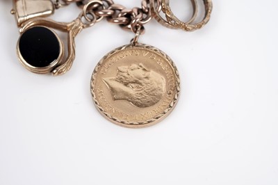Lot 649 - A 9ct yellow gold bracelet set with a sovereign and other charms