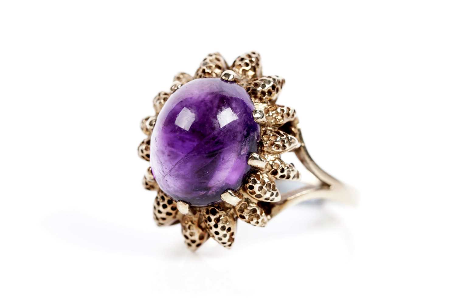 Lot 617 - An amethyst cabochon dress ring