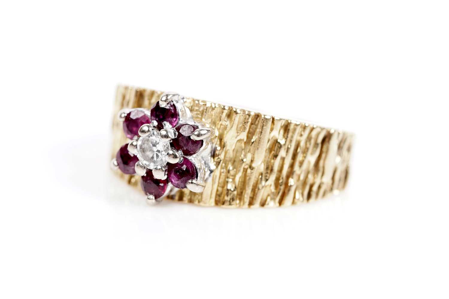 Lot 618 - A ruby and diamond flower cluster ring