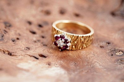 Lot 618 - A ruby and diamond flower cluster ring