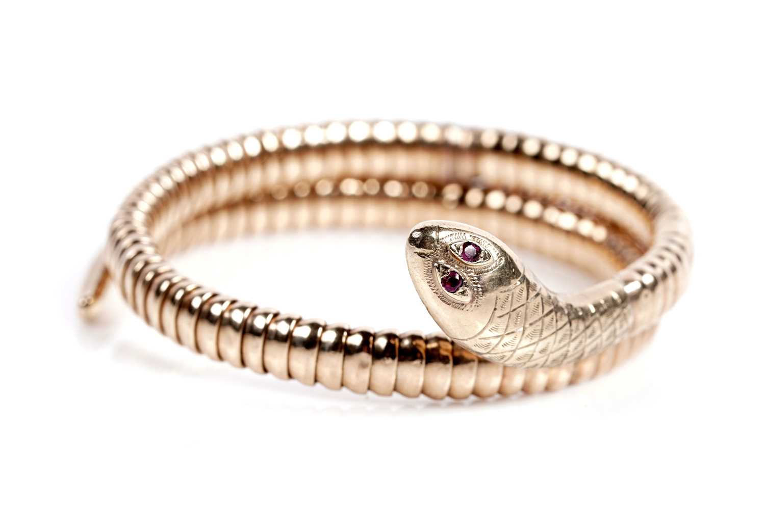 Lot 638 - A 9ct yellow gold snake pattern bangle