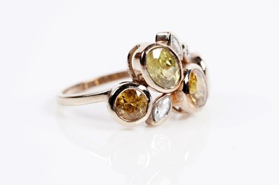 Lot 607 - A sphene and white stone dress ring