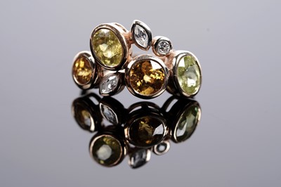 Lot 607 - A sphene and white stone dress ring