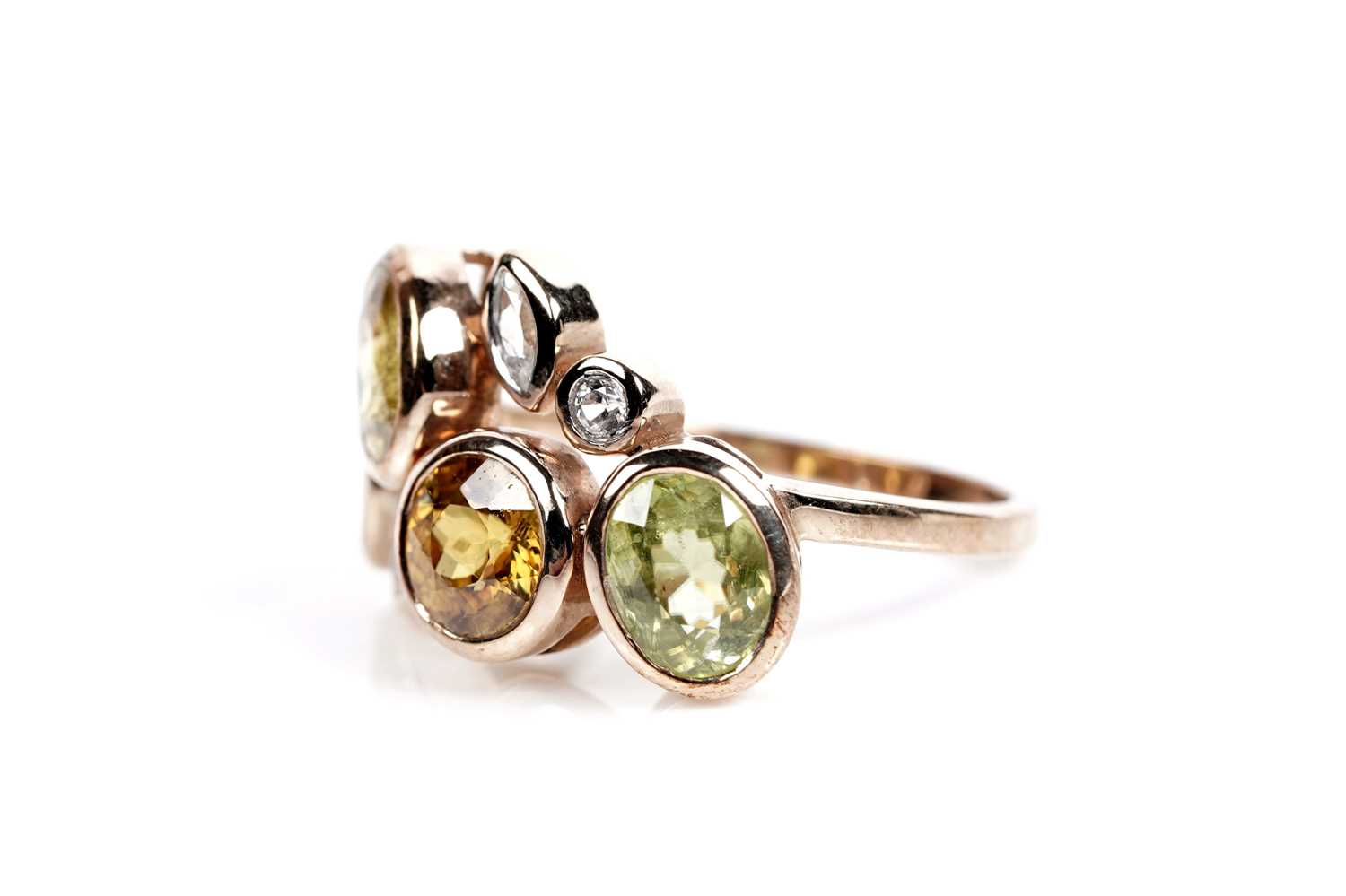 Lot 607 - A sphene and white stone dress ring