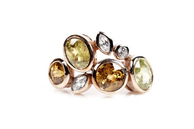 Lot 607 - A sphene and white stone dress ring