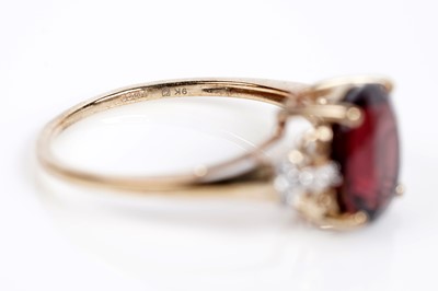 Lot 609 - A garnet and white sapphire dress ring