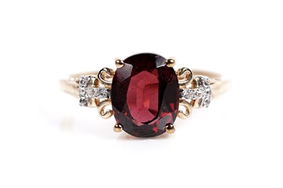 Lot 609 - A garnet and white sapphire dress ring