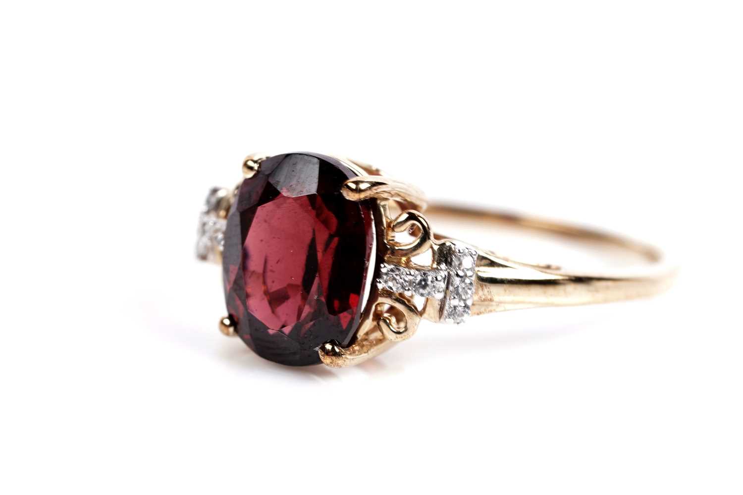 Lot 609 - A garnet and white sapphire dress ring