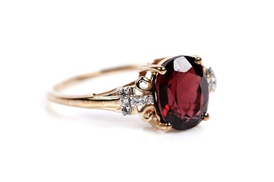 Lot 609 - A garnet and white sapphire dress ring