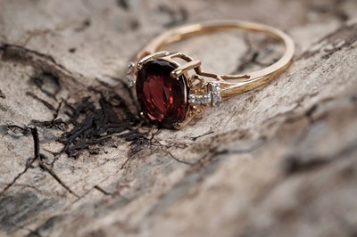 Lot 609 - A garnet and white sapphire dress ring