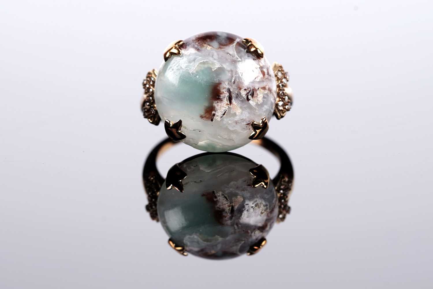 Lot 610 - A circular cabochon dress ring