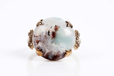 Lot 610 - A circular cabochon dress ring