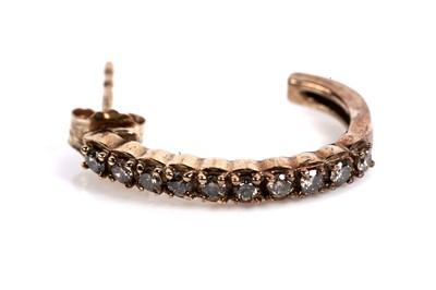 Lot 611 - A pair of diamond half hoop earrings