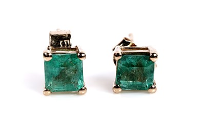 Lot 614 - A pair of emerald and white stone drop earrings; and a a pair of emerald stud earrings