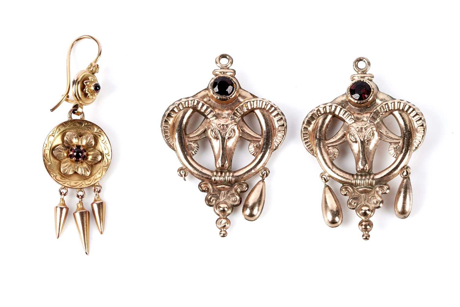 Lot 160 - A pair of garnet set ram's head pattern charm pendants; and an earring