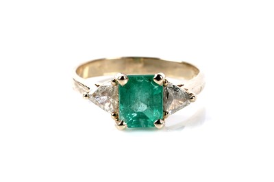 Lot 165 - An emerald and diamond three stone ring