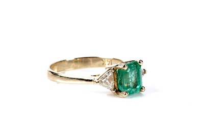 Lot 165 - An emerald and diamond three stone ring