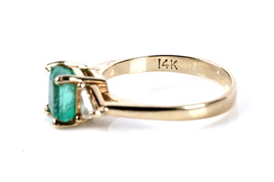Lot 165 - An emerald and diamond three stone ring
