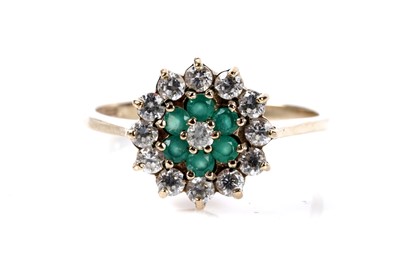 Lot 170 - An emerald and diamond cluster ring