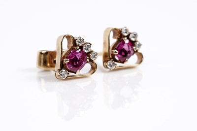 Lot 673 - A pair of ruby and diamond earrings