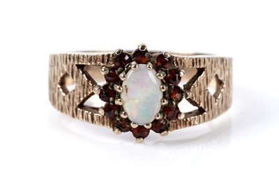 Lot 177 - An opal and garnet cluster ring