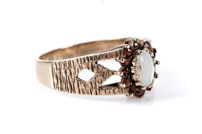 Lot 177 - An opal and garnet cluster ring