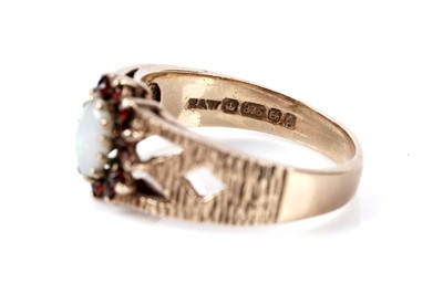 Lot 177 - An opal and garnet cluster ring