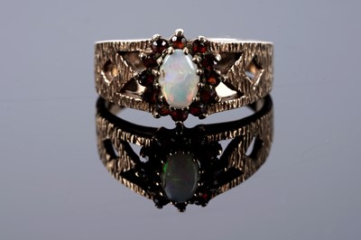 Lot 177 - An opal and garnet cluster ring