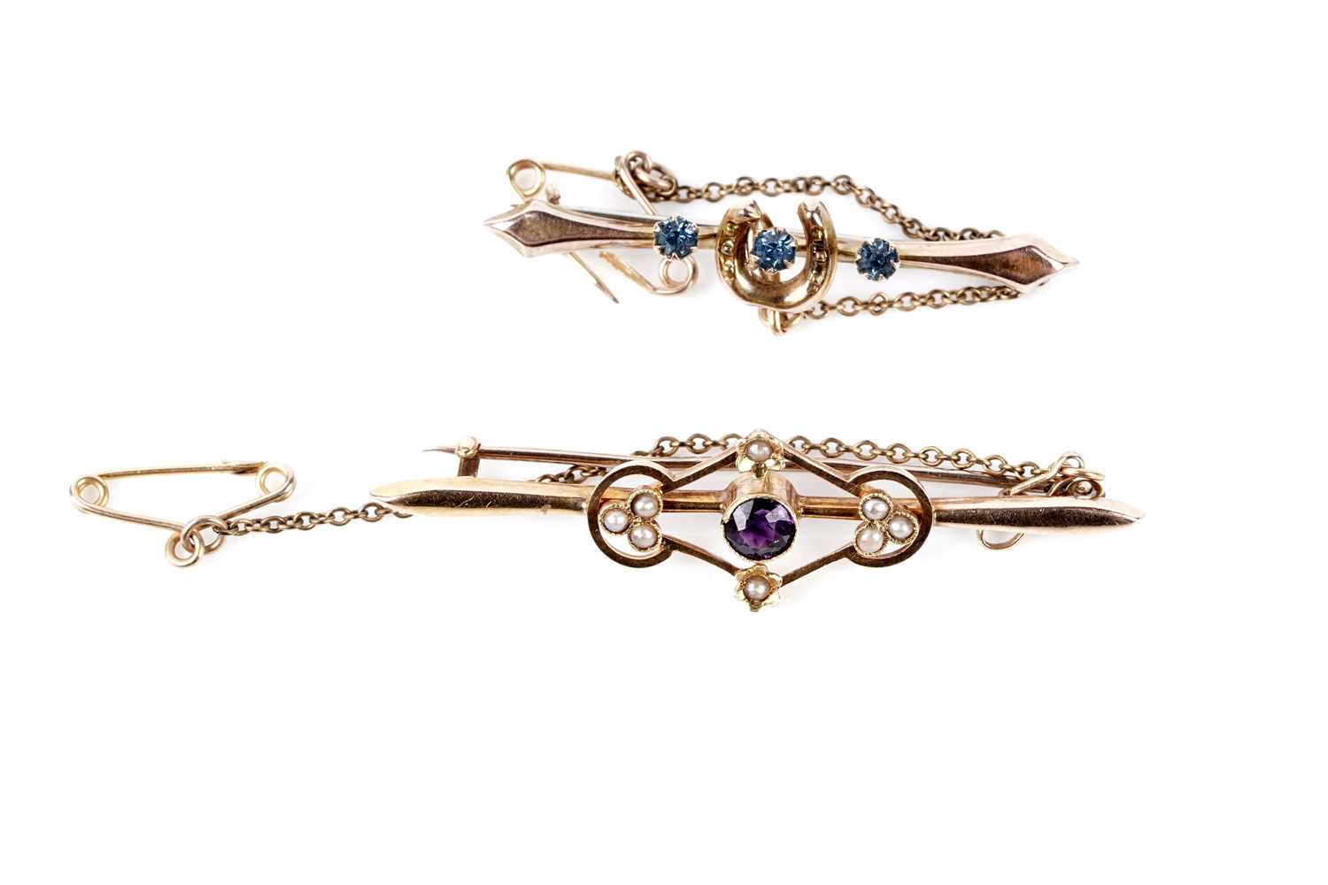 Lot 195 - An Edwardian amethyst and seed pearl bar brooch; and a horse shoe pattern bar brooch