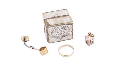 Lot 224 - Channel Isles (Guernsey): a small gold wedding band; and two 9ct gold charms